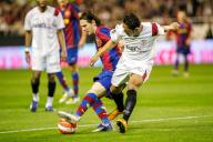 Intense duel as Messi and Adriano vie for the ball in Sevilla-Barcelona match