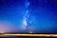Stellar view of the Milky Way galaxy shining above the Atlantic Ocean on El Palmar Beach