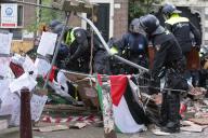 Dutch anti-riot police break through barricades set by students pro-Palestinian protest against the ongoing conflict Israel and the Palestinian at the University of Amsterdam on May 8, 2023 in Amsterdam,Netherlands