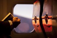 USA. Passenger aboard jet reading a book. Credit as: Don Paulson / Jaynes Gallery / DanitaDelimont.com