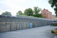 26 April 2024, Berlin: Rolled barbed wire can be seen above the walls of Plötzensee Prison. Photo: Annette Riedl\/dpa