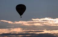 27 April 2024, Bavaria, Pfronten: A hot air balloon glides over the Alpine foothills in the early morning. Photo: Karl-Josef Hildenbrand\/dpa