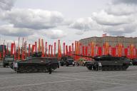 28 April 2024, Russia, Moskau: A German Leopard 2 main battle tank captured in Ukraine, according to Russian sources, and a Marder (left) stand at a display of war trophies in Pobedy Park (Park of Victory). In the background are red flags with the inscription Pobeda! (in German: Victory). On May 9, Russia celebrates the day of the Soviet Union