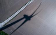 02 May 2024, Mecklenburg-Western Pomerania, Schönberg: A rotating wind turbine casts a shadow on a field in an energy park. (Aerial view with a drone) At the end of 2023, 1852 wind turbines with a total output of 3722 megawatts were connected to the grid in the north-east. Mecklenburg-Vorpommern therefore had a share of 6 percent of the wind turbine capacity installed nationwide. Photo: Jens Büttner\/dpa