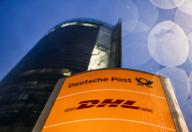 03 May 2024, North Rhine-Westphalia, Bonn: The logos of Deutsche Post and DHL stand in front of the Posttower. Deutsche Post AG holds its Annual General Meeting. The company has changed its name to DHL, except on the stock exchange, where it is still called Deutsche Post AG. Photo: Oliver Berg\/dpa