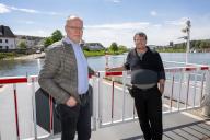 PRODUCTION - 27 April 2024, Oberbillig: Andreas Beiling (left, mayor of Oberbillig) and skipper Dieter Feldmann stand at the safety barrier on the Sankta Maria II ferry. It crosses the Moselle about 100 times between Oberbillig (Germany) and Wasserbillig (Luxembourg). (to dpa text: Living Europe - How the Moselle ferry connects Germany and Luxembourg) Photo: Harald Tittel\/dpa