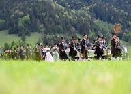 dpatop - 05 May 2024, Bavaria, Lenggries: Men in traditional costume march in the procession of the patron saint\'s day of the Bavarian mountain marksmen. Around 4000 marksmen celebrate in honor of the Mother of God, who is their patron saint. Photo: Angelika Warmuth\/dpa