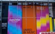 06 May 2024, Sweden, Malmö: Advertising boards for the EuroVision Song Contest hang behind a metal fence at the Malmö Arena venue. The colorful music spectacle is taking place in the southern Swedish city this week and is being accompanied by heavy security measures due to fears of protests. Photo: Jens Büttner\/dpa