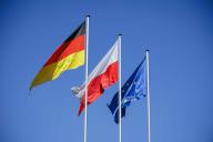 The flags of Poland, Germany and the European Union flutter in the wind against a blue sky. S\u0098Çubice, 01.05.2024 Slubice, 01.05.2024