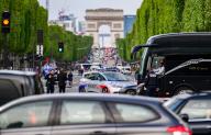 06 May 2024, France, Paris: Police officers stand on the Place de la Concorde on the Avenue des Champs-Elysees, with the Arc de Triomphe in the background. The Olympic Games and Paralympics are being held in France this summer. Photo: Robert Michael\/dpa