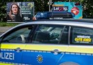 08 May 2024, Saxony, Leipzig: A Saxon police patrol car drives past election posters for the Greens (l-r), CDU and SPD. The Saxon police want to work closely with the parties to ensure the safety of campaigners and election workers in the state. In addition to the European elections, local elections will also be held in Saxony on June 9th, with the state elections taking place on September 1st. Photo: Jan Woitas/dpa