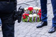 09 May 2024, Berlin: A memorial wreath with a ribbon in the colors of Russia lies on the ground in front of a policeman at the entrance to the Soviet Memorial in Treptower Park. May 8 and 9 marks the 79th anniversary of the liberation from National Socialism. Photo: Christoph Soeder\/dpa