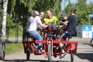 09 May 2024, Saxony-Anhalt, Darlingerode: A group of men from Rieder are out and about on a "party bike" celebrating Ascension Day. Photo: Matthias Bein\/dpa