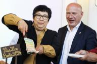 10 May 2024, Berlin: Seyran Ates (l), initiator and co-founder of the Ibn Rushd Goethe Mosque in Berlin, hands Kai Wegner (CDU), Governing Mayor of Berlin, a piece of "Kiss-Kiss Rainbow Cake" in the run-up to the Day against Homo-, Bi-, Inter- and Transphobia in the Rotes Rathaus. The international day against homo-, bi-, inter- and transphobia takes place on May 17. Photo: Carsten Koall/dpa