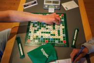 10 May 2024, North Rhine-Westphalia, Minden: Scrabble players sit at a game table on the occasion of the 14th German Scrabble Championship in Minden and place words in German. 64 participants from Germany, Austria and Switzerland will be competing. Photo: Friso Gentsch/dpa