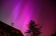 11 May 2024, Lower Saxony, Eldagsen: Northern lights can be seen behind a weathercock at Wülfinghausen Monastery near Eldagsen, south of Hanover. The northern lights (aurora borealis) are produced by a cloud of electrically charged particles from a solar storm in the earth