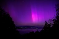 11 May 2024, Kochel: Northern lights sparkle in the night sky over Lake Kochel in Bavaria. Photo: Matthias Balk/dpa