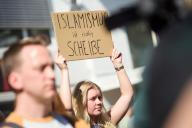 11 May 2024, Hamburg: A demonstrator holds up a sign reading "Islamism is really shit" at a counter-rally to an event organized by the Islamist network Muslim Interaktiv in Hamburg