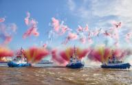 11 May 2024, Hamburg: Three tugboats set off fireworks during the tugboat ballet at the 835th Hamburg Port Birthday on the Elbe in the harbor. The people of Hamburg regard May 7, 1189 as the birthday of their port - back then, citizens were granted duty-free travel for their ships on the Elbe from the city to the North Sea. Photo: Georg Wendt/dpa