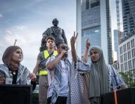11 May 2024, Hesse, Frankfurt/Main: Demonstrators chant slogans at a solidarity demonstration for Palestine in Frankfurt city center. In the background is the statue of Johann Wolfgang von Goethe, who was born in Frankfurt. Photo: Frank Rumpenhorst/dpa