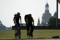 12 May 2024, Saxony, Dresden: Cyclists are silhouetted against the backdrop of the Frauenkirche. Photo: Sebastian Kahnert\/dpa
