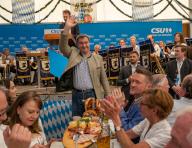 12 May 2024, Bavaria, Munich: Markus Söder (CSU), Prime Minister of Bavaria, waves in a beer tent. Söder visited the Truderinger Festwoche at the end of the festival. Photo: Stefan Puchner\/dpa