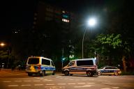 13 May 2024, Hamburg: Police emergency vehicles stand in front of a high-rise building in the Altona district after a person with a firearm triggered a large-scale operation. Photo: Jonas Walzberg/dpa