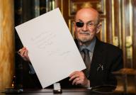 13 May 2024, Hamburg: The Indian-British writer Salman Rushdie shows his text after his entry in the city