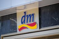 13 May 2024, Berlin: A sign with the logo of the drugstore chain dm is attached to a building on Alexanderplatz. Photo: Monika Skolimowska/dpa
