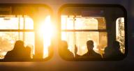 14 May 2024, Lower Saxony, Laatzen: Passengers sit at sunrise in a light rail vehicle operated by Hanover