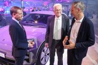 14 May 2024, Saxony, Leipzig: Michael Kretschmer (l-r, CDU), Minister President of Saxony, Winfried Kretschmann (Greens), Minister President of Baden-Württemberg, and Porsche CEO Oliver Blume stand next to an all-electric Porsche Macan at the start of production at the Leipzig plant. The sports car manufacturer has invested around 600 million euros in the expansion of the plant. The new Macan is the second all-electric Porsche model. The Leipzig plant is designed for maximum flexibility in the future. Gasoline, hybrid and fully electric vehicles will run on a shared production line. Porsche aims to deliver more than 80 percent of new vehicles with purely electric drive systems by 2030. Photo: Jan Woitas/dpa
