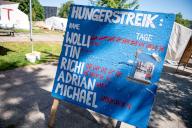 15 May 2024, Berlin: The names of the hunger strikers and the duration of the hunger strike are written on a sign. One of the hunger strikers collapsed in the climate camp at Invalidenpark. Photo: Fabian Sommer/dpa