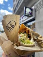 15 May 2024, Great Britain, London: The Taco Bell logo and a burrito can be seen outside a branch of the chain in London. The US fast food chain Taco Bell is expanding into the German market. The first restaurant will open in Berlin this summer, with more to follow. Photo: Julia Kilian/dpa