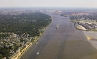 14 May 2024, Hamburg: View across the Elbe off Hamburg with Blankenese (l), Airbus plant Finkenwerder (r) in the direction of the port and city center (aerial view). Photo: Christian Charisius/dpa