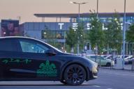 16 May 2024, Brandenburg, Grünheide: A Tesla with a turtle and the slogan "Giga - At home in Grünheide" is parked in front of the Tesla plant in the early morning. Accompanied by protests, the community of Grünheide southeast of Berlin is voting this Thursday on expansion plans for the US electric car manufacturer Tesla. Photo: Joerg Carstensen/dpa