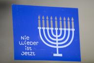 PRODUCTION - 22 March 2024, Hesse, Frankfurt/Main: A sticker with the words "Never again is now" and the Hanukkah candelabrum is emblazoned on a door of the Bockenheim depot as a sign against anti-Semitism, hatred and hate speech. The conflict in the Middle East is also having an impact on Hesse: The Ministry of the Interior is registering an increase in anti-Semitic crimes. Photo: Arne Dedert/dpa