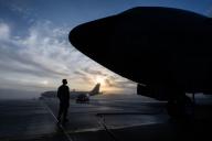 16 May 2024, Rhineland-Palatinate, Spangdahlem: A soldier waits at a US Air Force KC-135 Stratotanker in the morning fog in the first light of day at Spangdahlem Airbase. The Stratotanker can be used to refuel NATO fighter jets in the air. Photo: Boris Roessler/dpa