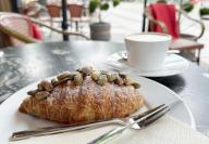 25 April 2024, Berlin: A pistachio croissant lies on a plate in a café. Photo: Gregor Tholl\/dpa