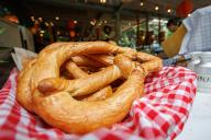 16 May 2024, Bavaria, Erlangen: Large pretzels are on sale at a stand during the Erlangen Bergkirchweih. In the afternoon, the Kirchweih is opened with the traditional tapping of the keg beer. The Bergkirchweih - also known as "Berg" for short - ends on May 27. Photo: Daniel Karmann\/dpa