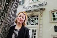 PRODUCTION - 25 April 2024, North Rhine-Westphalia, Cologne: Mareike Marx, director of the Hänneschen Theater, stands in front of the house. The Hänneschen Theater has been in existence for 222 years. It is one of the largest and oldest puppet theaters in Germany. Photo: Oliver Berg/dpa