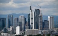 PRODUCTION - 16 May 2024, Hesse, Frankfurt/Main: The high-rise buildings stand close together and characterize the backdrop of the banking city. Photo: Arne Dedert/dpa