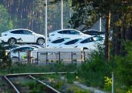 dpatop - 17 May 2024, Brandenburg, Grünheide: Tesla cars are parked for transportation at the edge of the forest on the eastern part of the Tesla Gigafactory site. On Thursday evening, municipal representatives from Grünheide approved a development plan that clears the way for an expansion of the Tesla factory. The car manufacturer wants to expand its site to include a freight yard and logistics areas. Photo: Soeren Stache/dpa