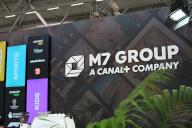 14 May 2024, North Rhine-Westphalia, Cologne: Logo, lettering of M7 Group, a Luxembourg-based television provider belonging to the French media group Canal+ at a stand at Anagacom, Europe