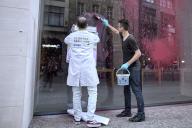 17 May 2024, Berlin: Activists smear an Apple store with red paint. Environmental activists from the group Scientist Rebellion smeared a store belonging to the US technology company Apple with paint in Berlin-Mitte on Friday morning. They did so to protest against the dangerous working conditions in the Democratic Republic of Congo when extracting the raw material cobalt needed for cell phones and other products, as the group announced in Berlin. Photo: Michael Ukas/TNN/dpa/dpa
