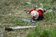 17 May 2024, North Rhine-Westphalia, Duesseldorf: Debris and a stuffed Santa Claus lie on the lawn in front of the house where a fire raged. Following the explosion and devastating fire in a residential and commercial building in Düsseldorf that left three people dead, the police are continuing their investigation on Friday. The focus remains on the still unclear cause of the explosion and the subsequent fire. Photo: Federico Gambarini/dpa