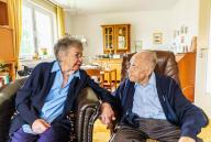 17 May 2024, Rhineland-Palatinate, Bad Sobernheim: Ursular (l) and Gottfried Schmelzer sit together in their living room. 98-year-old Ursular and 103-year-old Gottfried are celebrating their 80th wedding anniversary. According to the State Chancellery, this makes them the longest married couple in Germany. Photo: Andreas Arnold/dpa