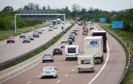 17 May 2024, Saxony, Wiedemar: Numerous cars and trucks are driving in both directions on the A9 at the Schkeuditzer Kreuz junction. The ADAC expects heavy travel traffic in Saxony before the Whitsun weekend. Photo: Jan Woitas/dpa