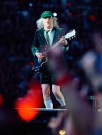17 May 2024, North Rhine-Westphalia, Gelsenkirchen: AC/DC Power Up Tour - start of the German tour, Veltins Arena. Angus Young, lead guitarist, plays on the catwalk in front of the stage. Photo: Bernd Thissen/dpa