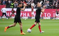 18 May 2024, Hesse, Frankfurt\/Main: Soccer: Bundesliga, Eintracht Frankfurt - RB Leipzig, Matchday 34, Deutsche Bank Park. The two Frankfurt players Makoto Hasebe (l) and Sebastian Rode come onto the pitch before the game. Photo: Arne Dedert\/dpa - IMPORTANT NOTE: In accordance with the regulations of the DFL German Football League and the DFB German Football Association, it is prohibited to utilize or have utilized photographs taken in the stadium and\/or of the match in the form of sequential images and\/or video-like photo series