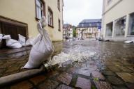19 May 2024, Saarland, Blieskastel: Water is being pumped out of flooded cellars in the old town. The water level of the Blies, a tributary of the Saar, is currently falling and the fire department has largely pumped out the historic old town. Photo: Andreas Arnold/dpa